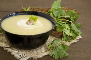 Homemade diet mushroom soup on a wooden table.