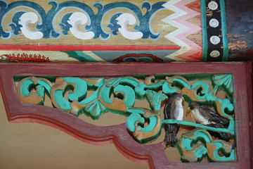 Exterior wood carving and painting, buddhist and religious decoration and art of tibetian monastery and meditation center at Terelji National Park, Mongolia, Asia
