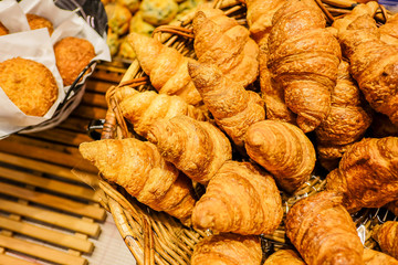 freshly baked croissants in the basket ,food concept background with copy space.