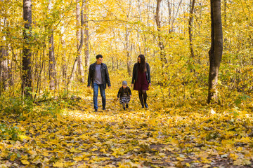 Fototapeta premium Children, nature and family concept - Portrait of happy family over autumn park background