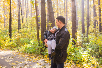 Fototapeta premium Happy family father and child daughter on a walk in autumn park