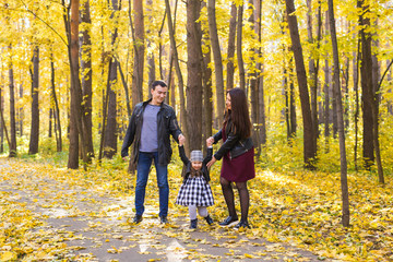 Fototapeta premium Children, nature and family concept - Portrait of happy family over autumn park background