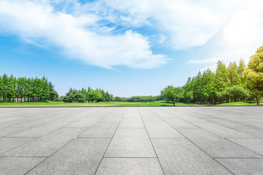 Empty square floor and green forest natural scenery in the city park