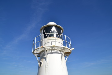 White lighthouse blue sky in summer