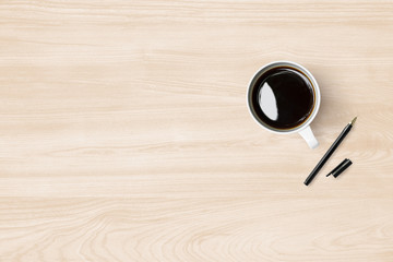 Wood office desk table with cup of cofee and pen. Top view with copy space, flat lay.