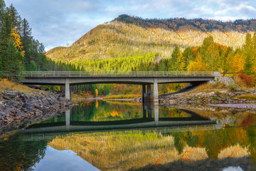 Fototapeta na wymiar McDonald Creek bridge in autumn colors, Glacier National Park, Montana