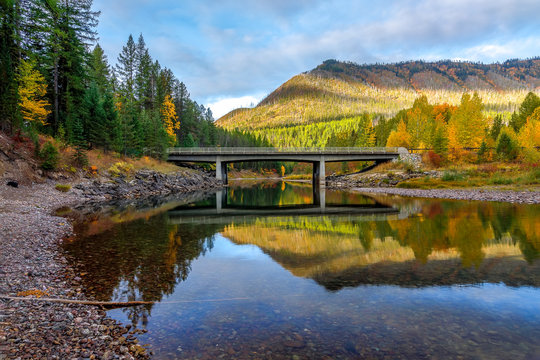 bridge over a creek surrounded by autumn colors, Glacier National Park, Montana
