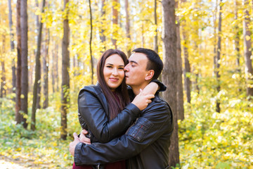 Cute couple outdoors in fall. Young man and woman in autumn nature