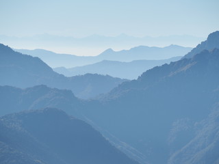 Landscape on hills and Alps mountains with humidity in the air and pollution. Panorama from Farno Mountain, Bergamo, Italy