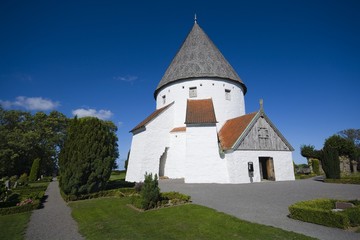 Fototapeta na wymiar Defensive round church in Olsker, Bornholm, Denmark. It is one of four round churches on the Bornholm island. Built about 1150, 26 meter high, considered the most elegant round church