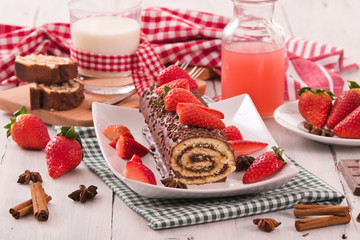 Chocolate roll with strawberries.