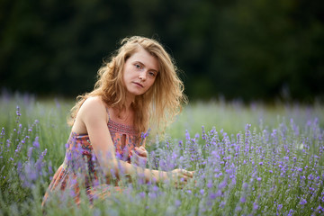 Farmer lady in floral dress in lavender field