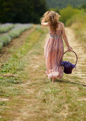 Farmer lady in floral dress in lavender field