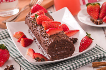 Chocolate roll with strawberries.