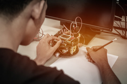 Asian Student thinking and learning STEM Education robotics for creating project based studying for innovation robot model. Study generation for DIY electronic Kit in computer teachnology classroom
