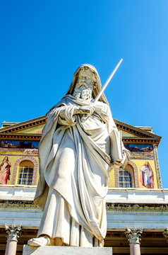 Statue of St. Paul on the background of the Basilica of San Paolo. Rome. Italy.

