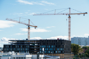 Cranes building house at construction site