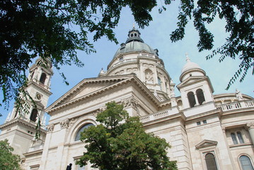 Fototapeta na wymiar Dome of Basilica of Saint Stephen in Budapest, Hungary, view through leaves