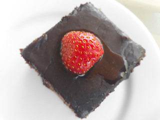 Chocolate brownie with strawberry on top