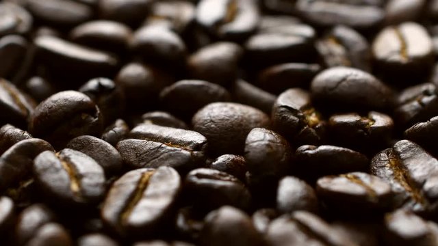 Coffee beans in dolly shot, sliding camera move, 4K