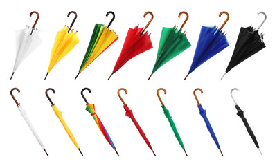 Set with different color umbrellas on white background