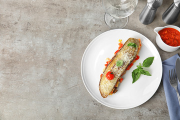 Flat lay composition with baked eggplant, tomatoes and basil on light table. Space for text