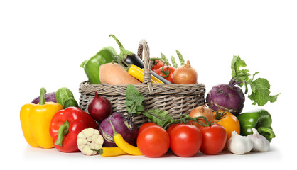 Many fresh ripe vegetables with basket on white background