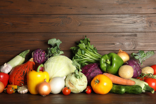 Many fresh ripe vegetables on wooden background. Organic food