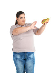 Overweight woman with hamburger on white background