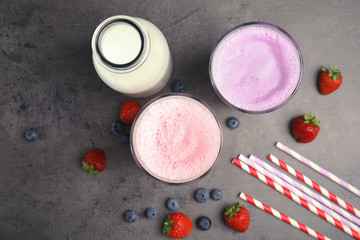 Flat lay composition with delicious milk shakes on grey background © New Africa