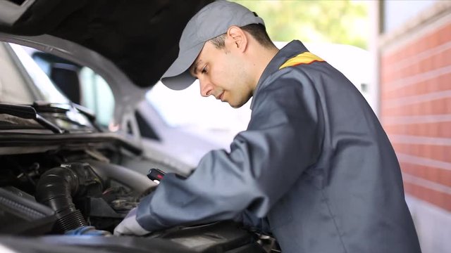 Mechanic checking a truck engine
