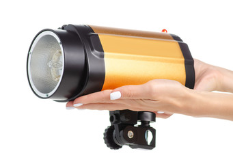 Studio flash equipment in hand on white background isolation