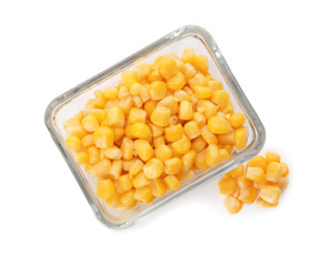 Bowl with corn kernels on white background, top view