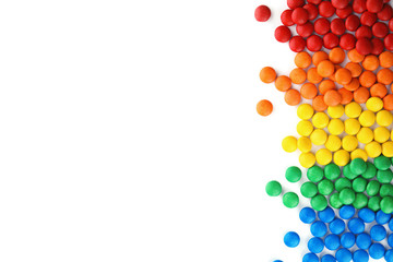 Tasty colorful candies on white background, top view