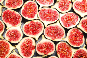 Cut ripe figs as background, top view