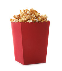 Red bucket with delicious caramel popcorn on white background