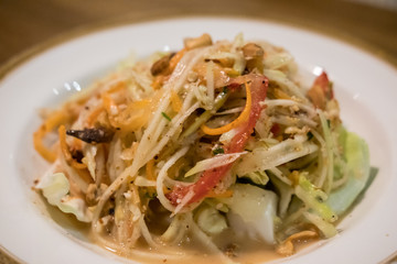 Som Tum, Thai papaya salad served on plate.