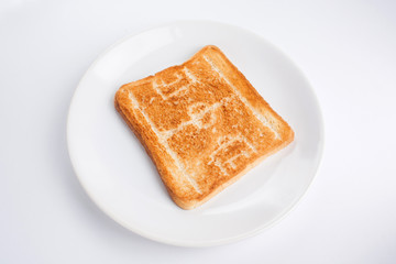 Pattern (picture) in the form of a silhouette of a football (soccer) field on a toasted bread on a plate on a white background
