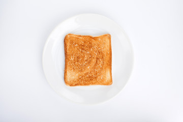 Toasted bread on a plate on a white background