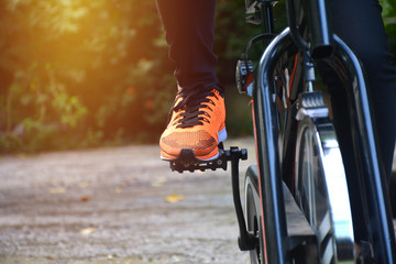 Naklejka premium Female exercising on bicycle for exercising and healthy lifestyle concept.