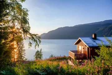 Foto op Canvas Wooden summerhouse with terrace overlooking scenic lake at sunset in Norway Scandinavia © Dmitry Naumov