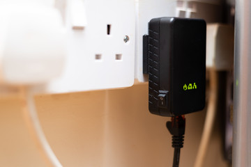 UK Powerline network adaptor, pluged into mains - obrazy, fototapety, plakaty