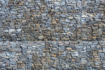 View of a stones in steel mesh cage as  background, texture