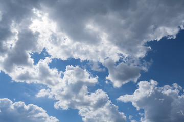 Fototapeta na wymiar Overcast gray clouds against a sunlight in sky