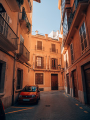 Fototapeta na wymiar red car in front of a spanish building