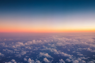 Flying above the clouds. Aerial view from the airplane - obrazy, fototapety, plakaty