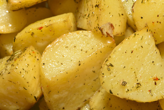 Appetizing and beautiful fried potatoes, yellow, with seasonings, close-up