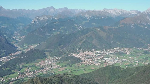 4K Drone aerial view to the Seriana valley and Orobie Alps in a clear and blue day. View of the highest mountains. Landscape from Pizzo Formico Mountain, Bergamo, Italy