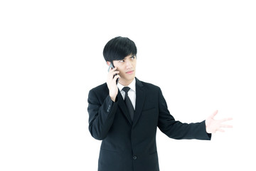 Asia businessman with black suit and black necktie has talking by  phone with upset isolated on white background.