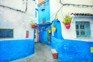 Blue color walls of houses with colorful flowerpots in Chefchaouen. Morocco, North Africa